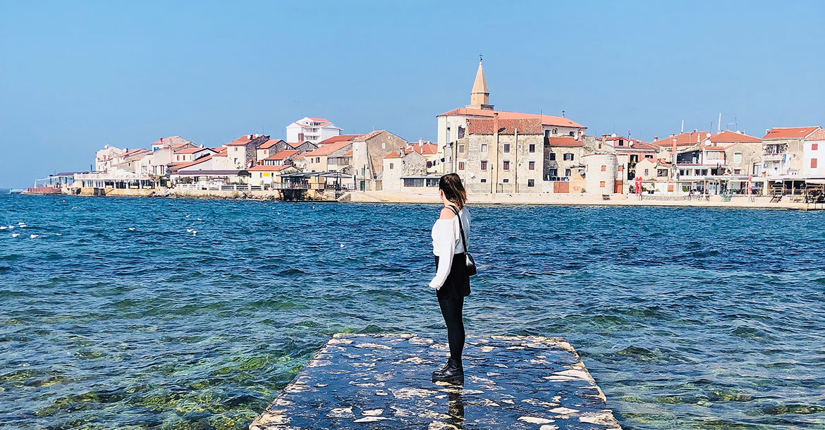 student, standing next to the ocean