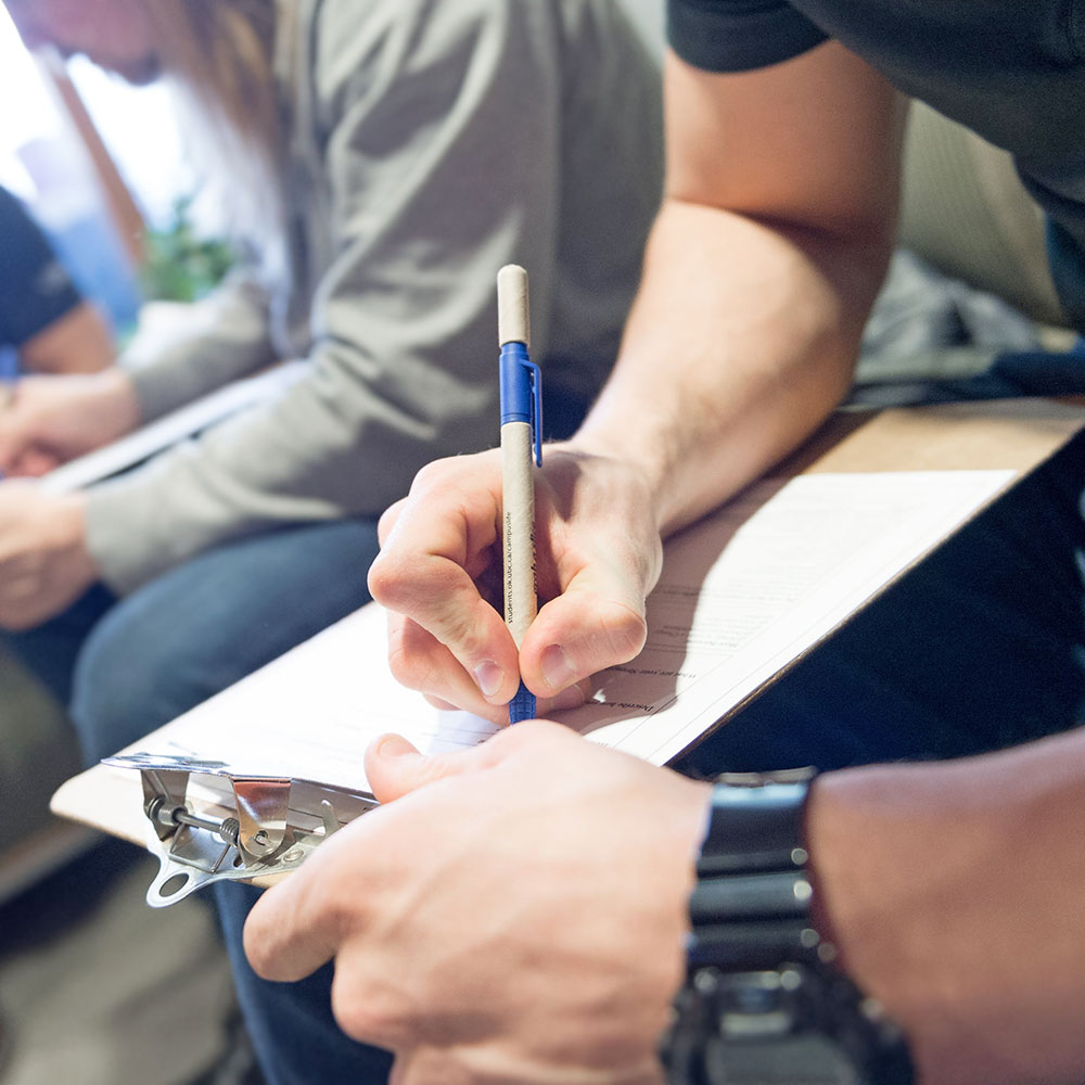 student filling out health insurance paperwork