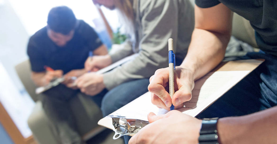 student filling out health insurance paperwork