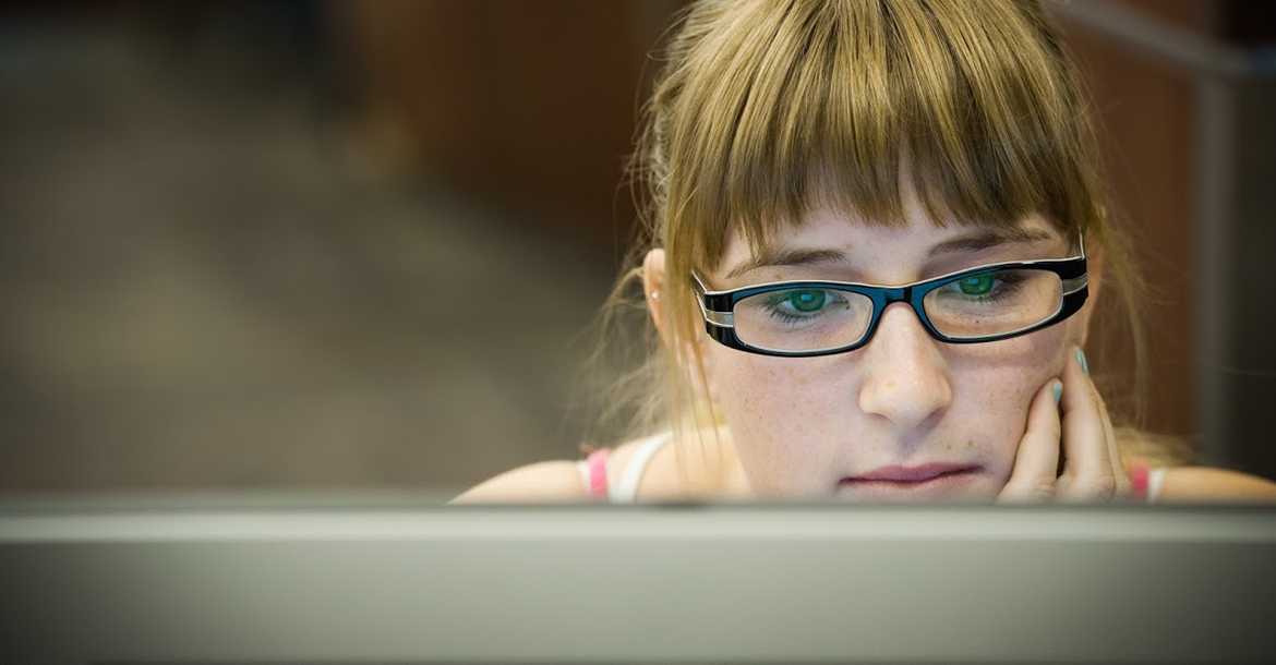 Student looking at a desktop computer