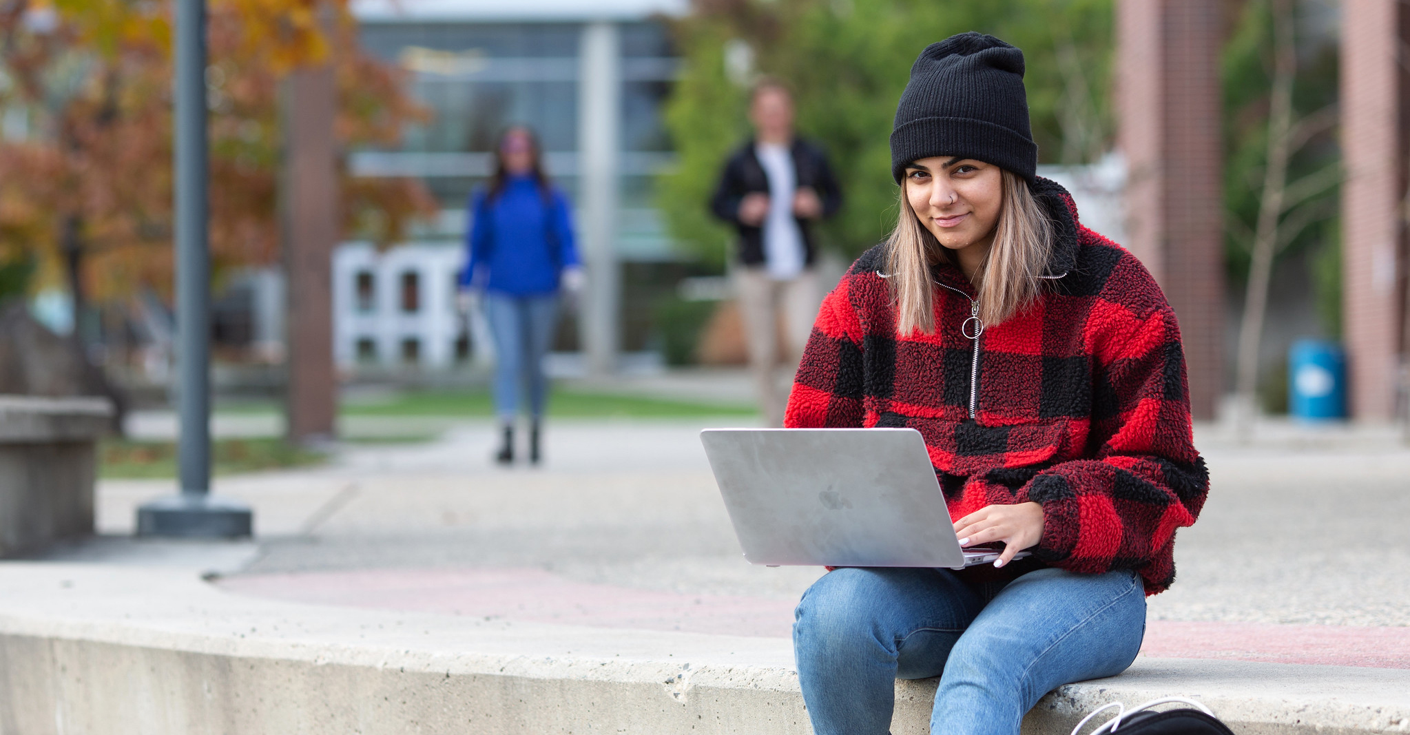 student outside with laptop