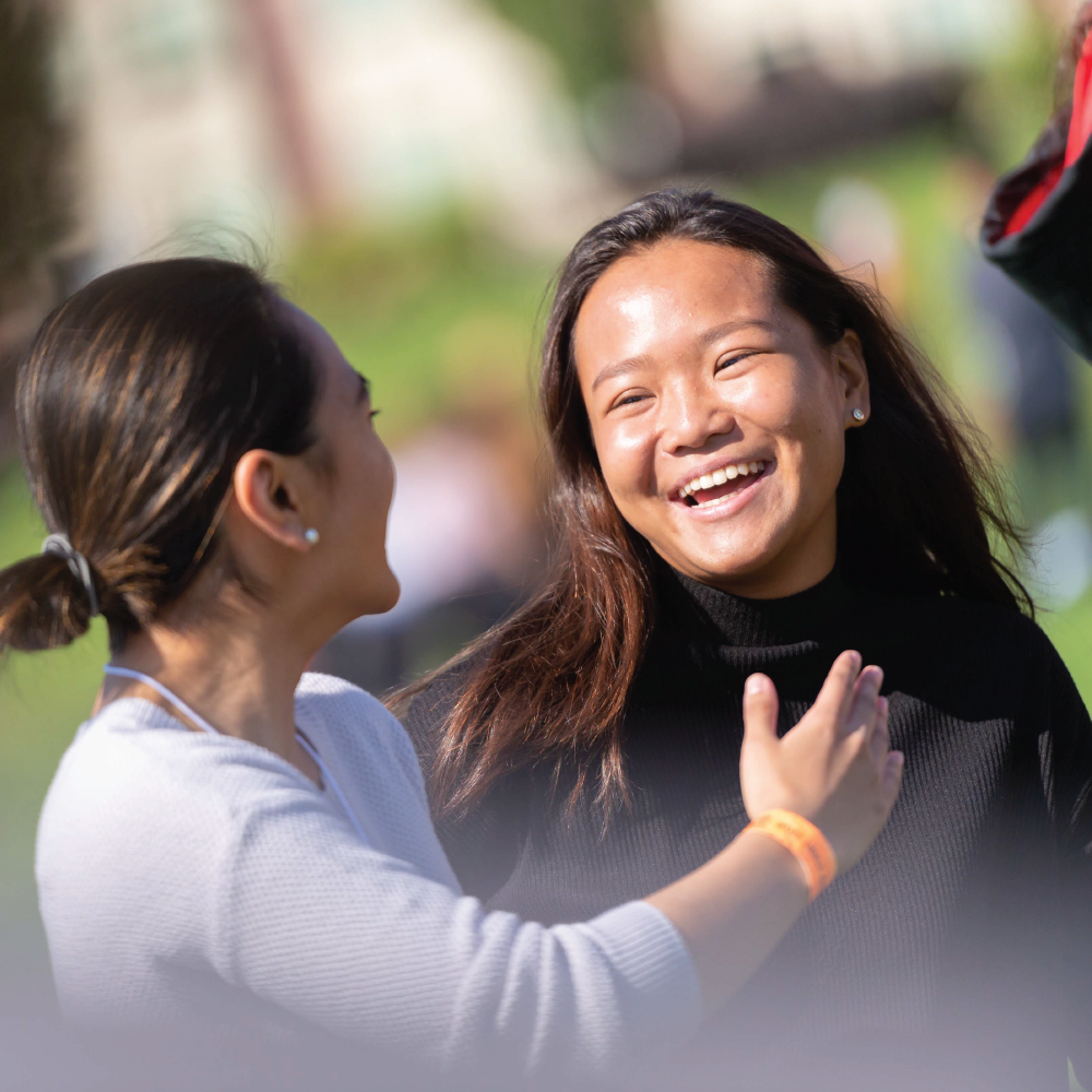 two students laughing and smiling at each other on the UBCO campus