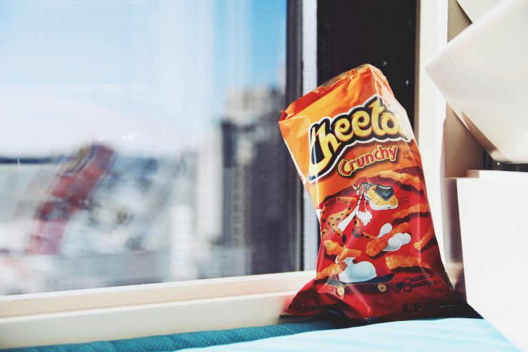 bag of spicy Cheetos by a window