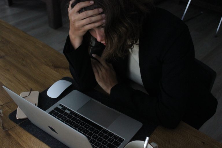 tired woman working on laptop